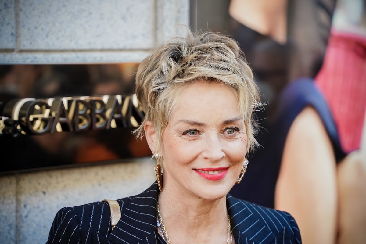 Sharon Stone smiling while wearing a black dress.