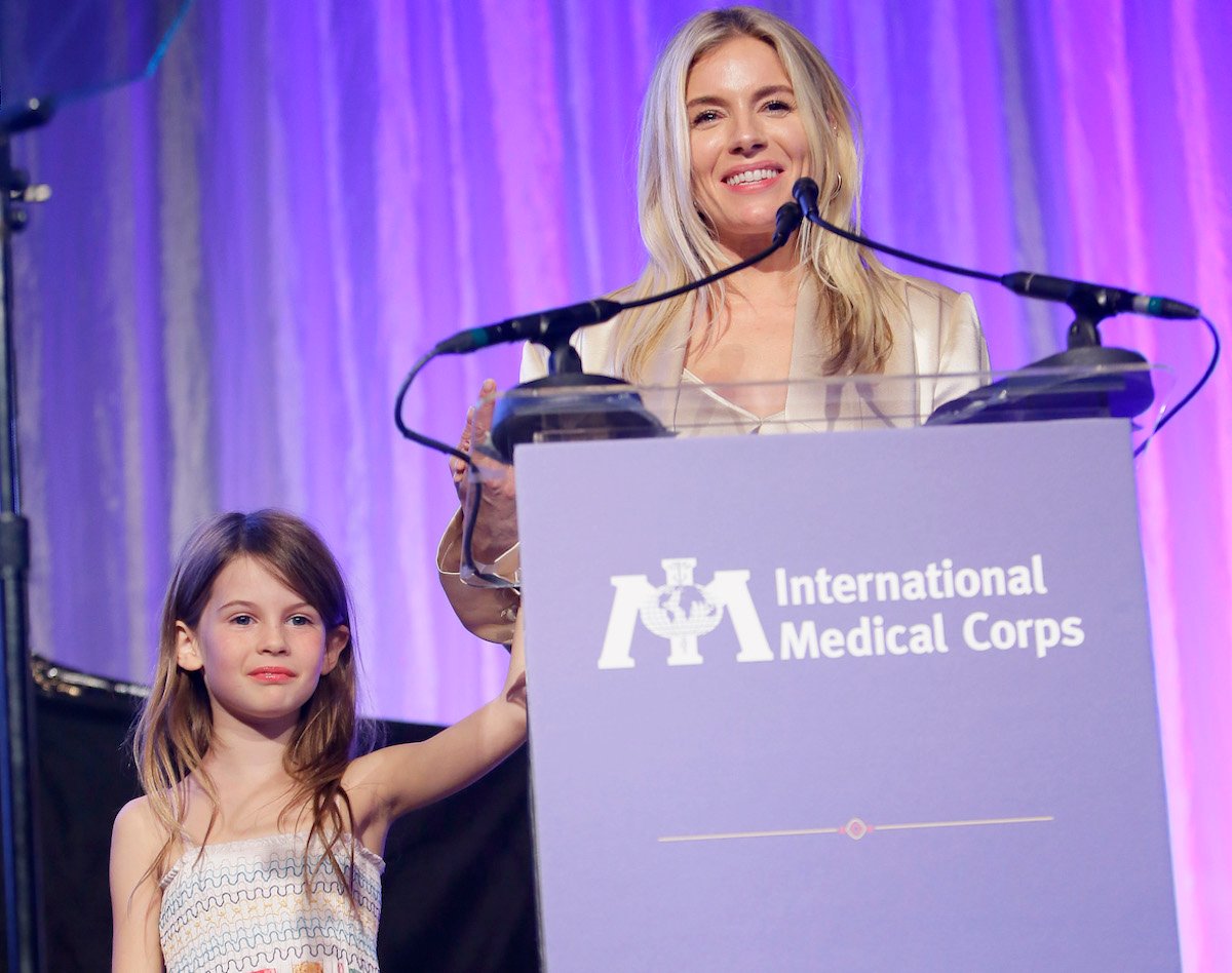 Sienna Miller's daughter Marlowe stands with the actor onstage