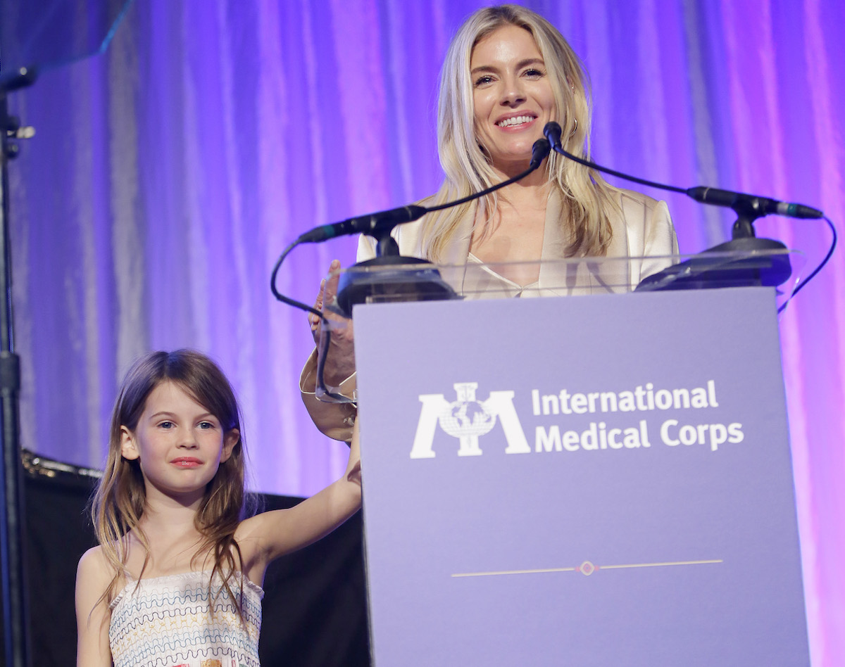 Sienna Miller's daughter Marlowe stands with the actor onstage