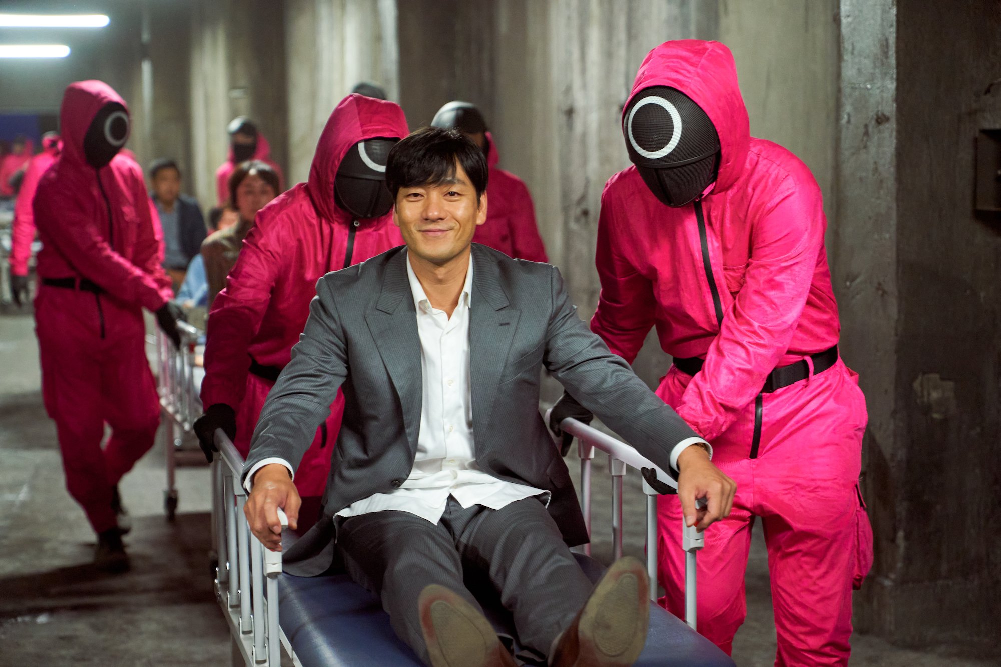 'Squid Game' star Park Hae-soo rides a gurney pushed by red guards