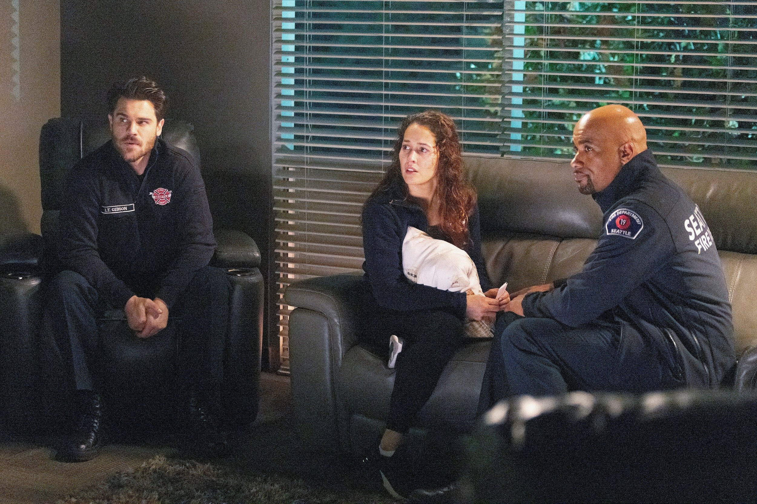 'Station 19' cast members Grey Damon, Jaina Lee Ortiz and Boris Kodjoe sitting together as Jack, Andy, and Sullivan