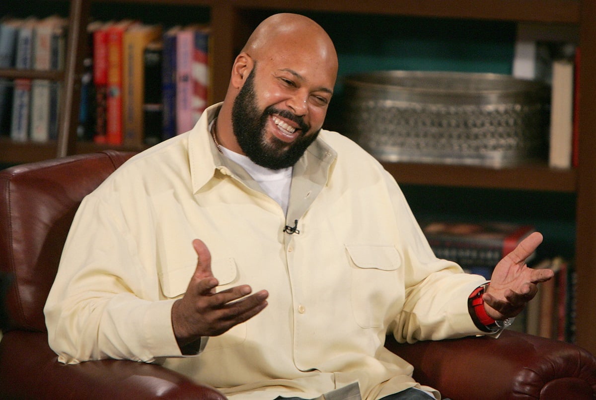Suge Knight smiling while wearing a yellow shirt.