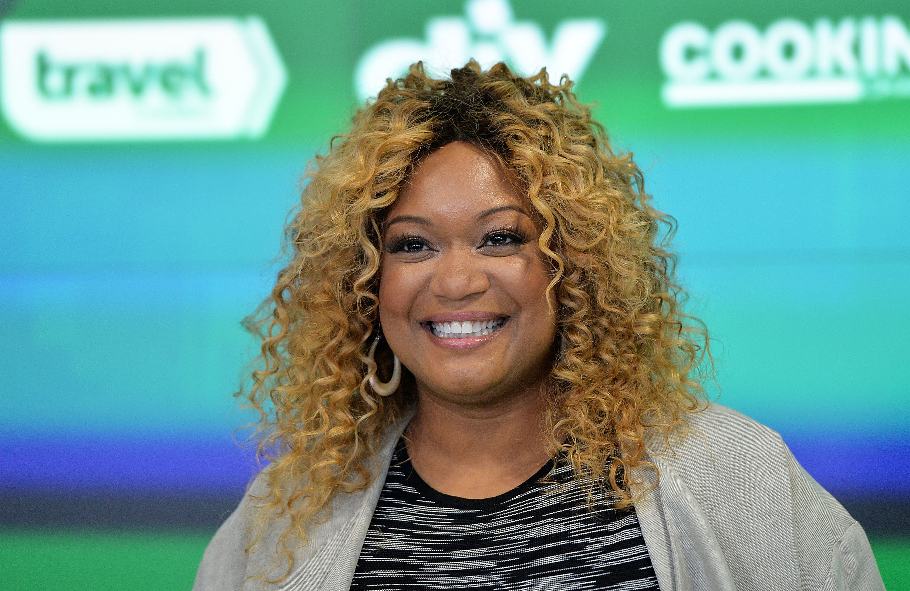 Food Network personality Sunny Anderson wears a black-and-white striped top in this photograph.