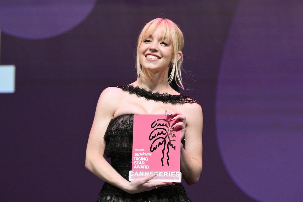 Sydney Sweeney smiles on stage of the Canneseries Festival