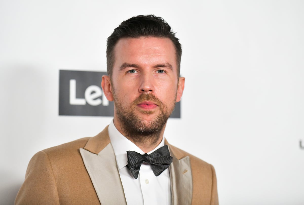 Wearing a brown suit jacket TJ Osborne attends Universal Music Grammy after party in LA.