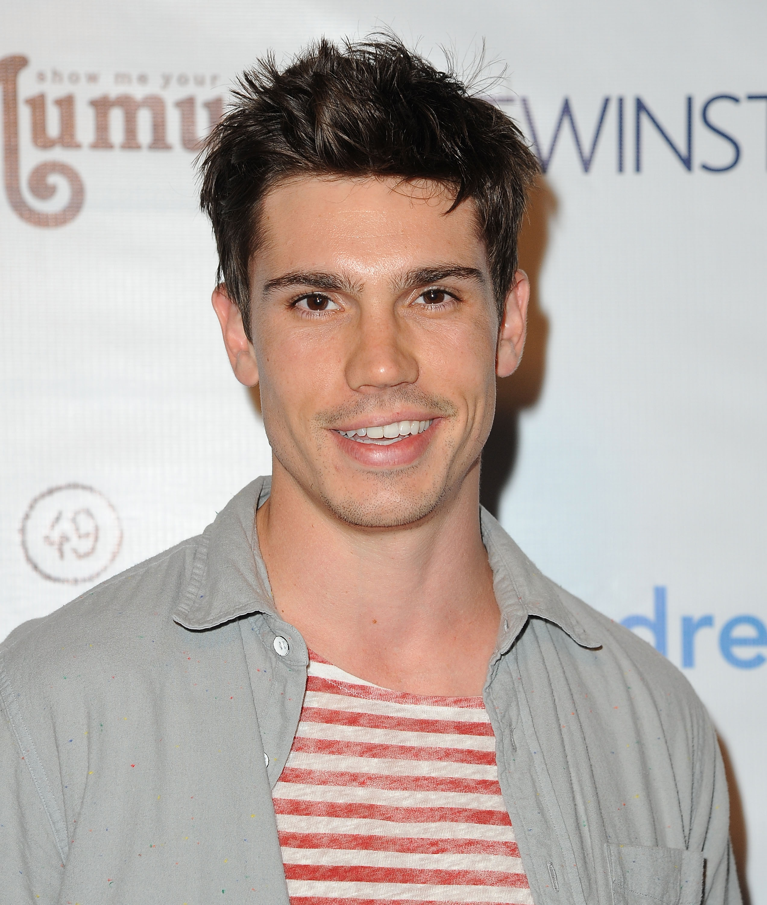 'The Bold and the Beautiful' actor Tanner Novlan wearing a red and white striped shirt, and a grey jacket.