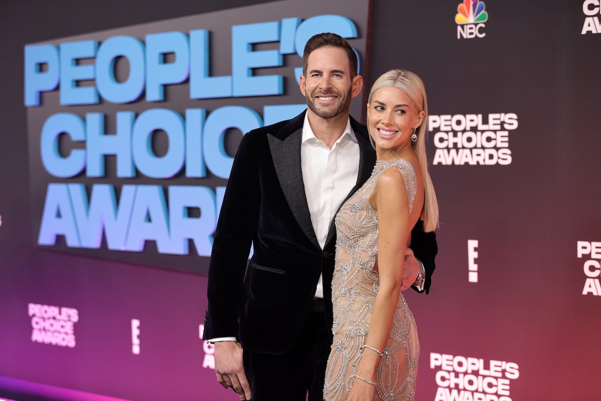 Tarek El Moussa and Heather Rae Young pose together at an event.