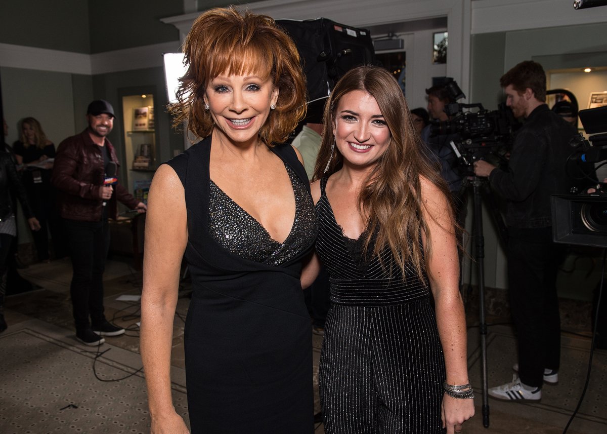 Wearing a black dress, Reba McEntire poses with Tenille Townes during the 2019 CMA Artist of the Year in Nashville, TN