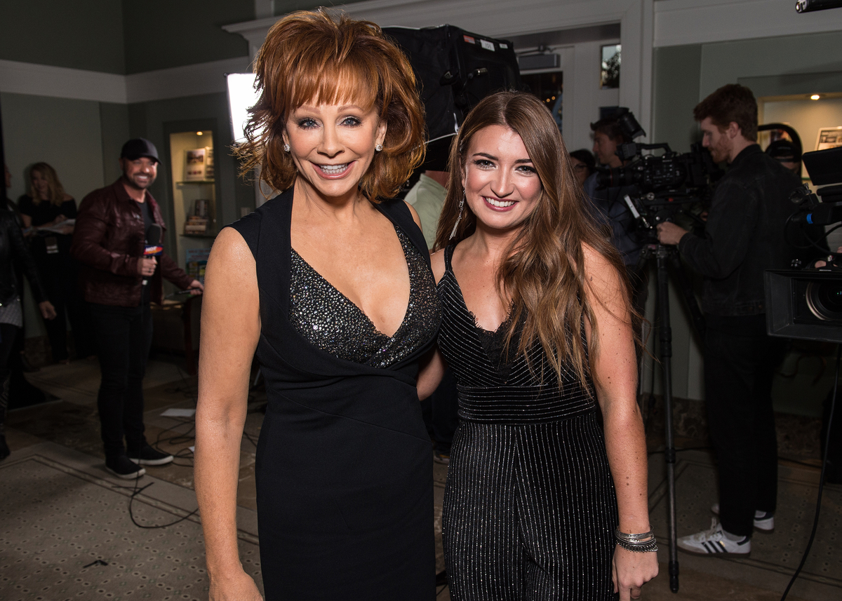 Wearing a black dress, Reba McEntire poses with Tenille Townes during the 2019 CMA Artist of the Year in Nashville, TN