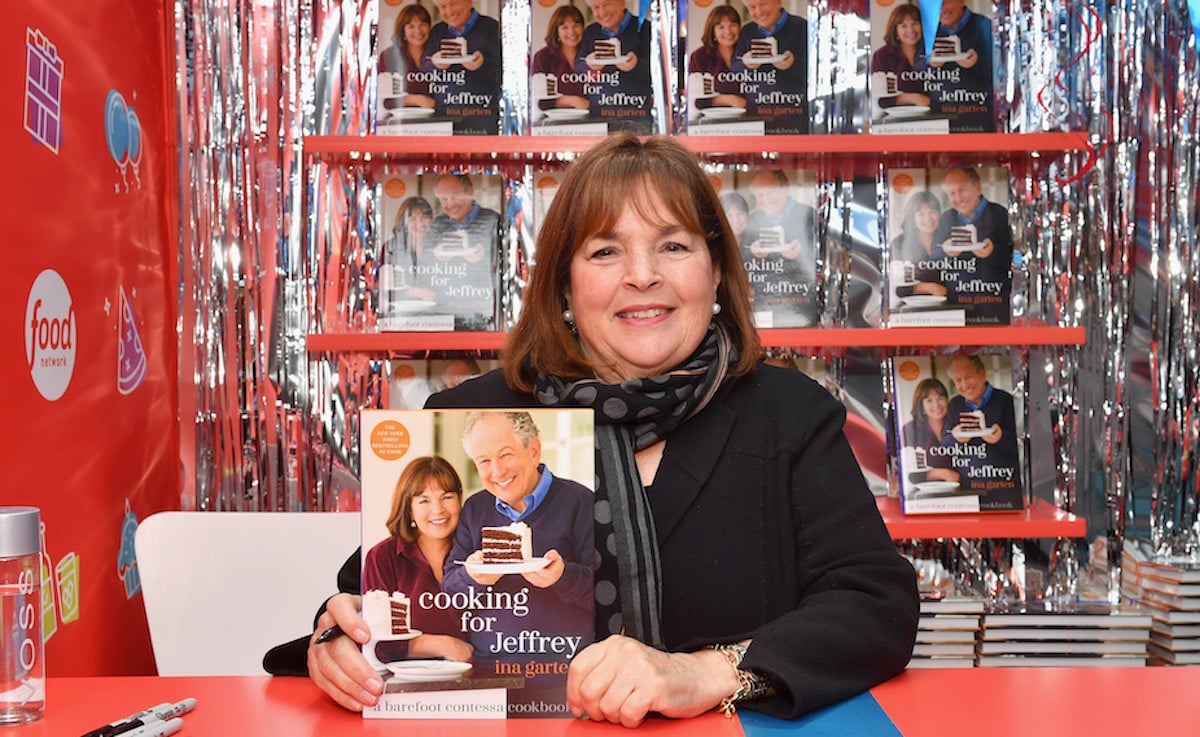 'The Barefoot Contessa Cookbook' author Ina Garten smiles holding up a copy of her book, 'Cooking for Jeffrey'