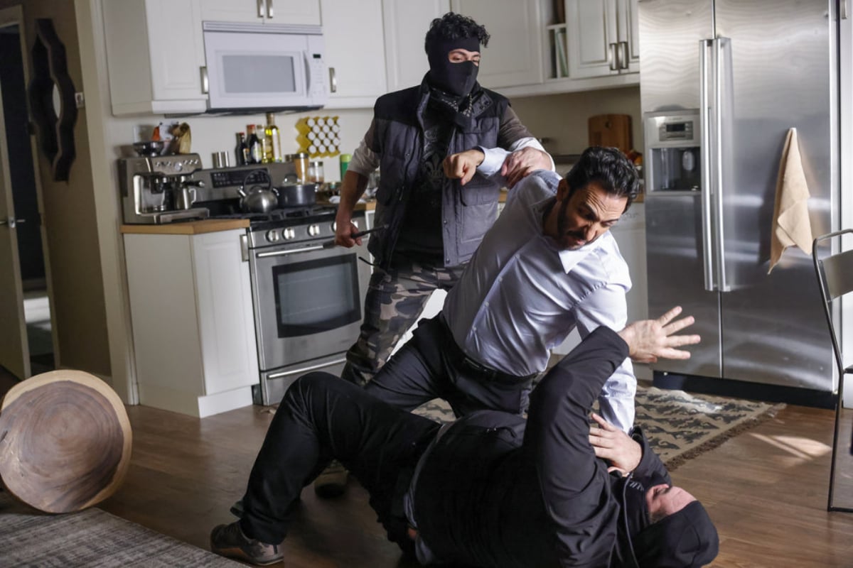 Amir Arison as Aram Mojtabai in The Blacklist'Season 9. Aram is about to punch a masked attacker on the ground when the other attacker grabs his arm. 