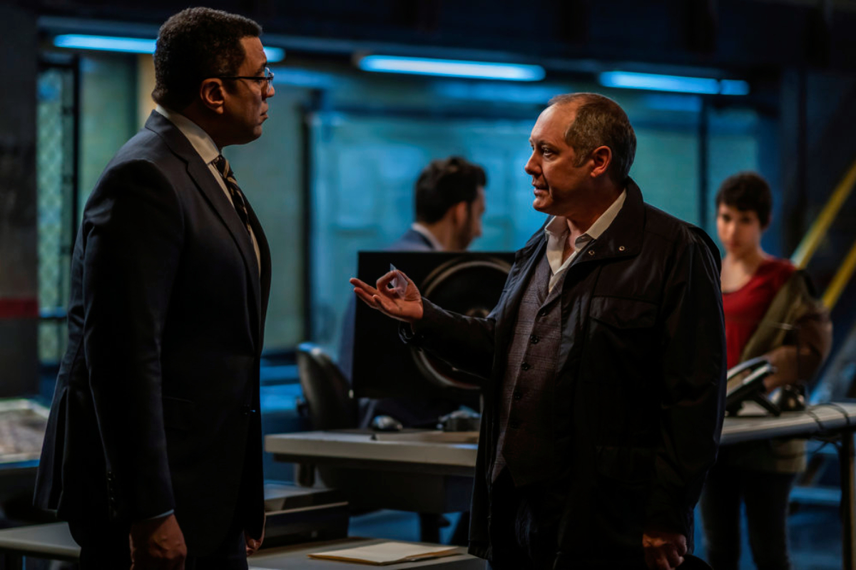Harold Cooper and Raymond Reddington in The Blacklist Season 9 Episode 15. Red holds something in a small bag while talking to Cooper.