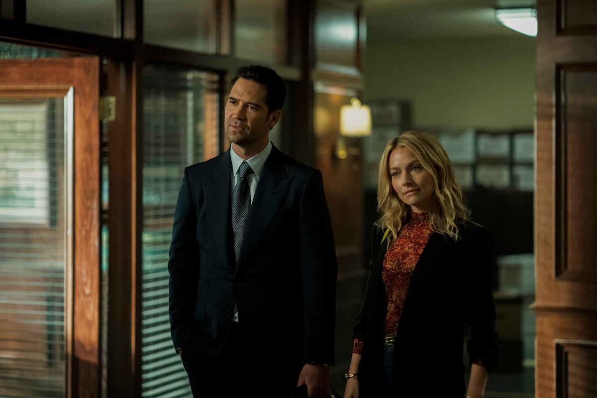 Manuel Garci-Rulfo as Mickey Haller standing next to Becki Newton as Lorna in 'The Lincoln Lawyer' on Netflix