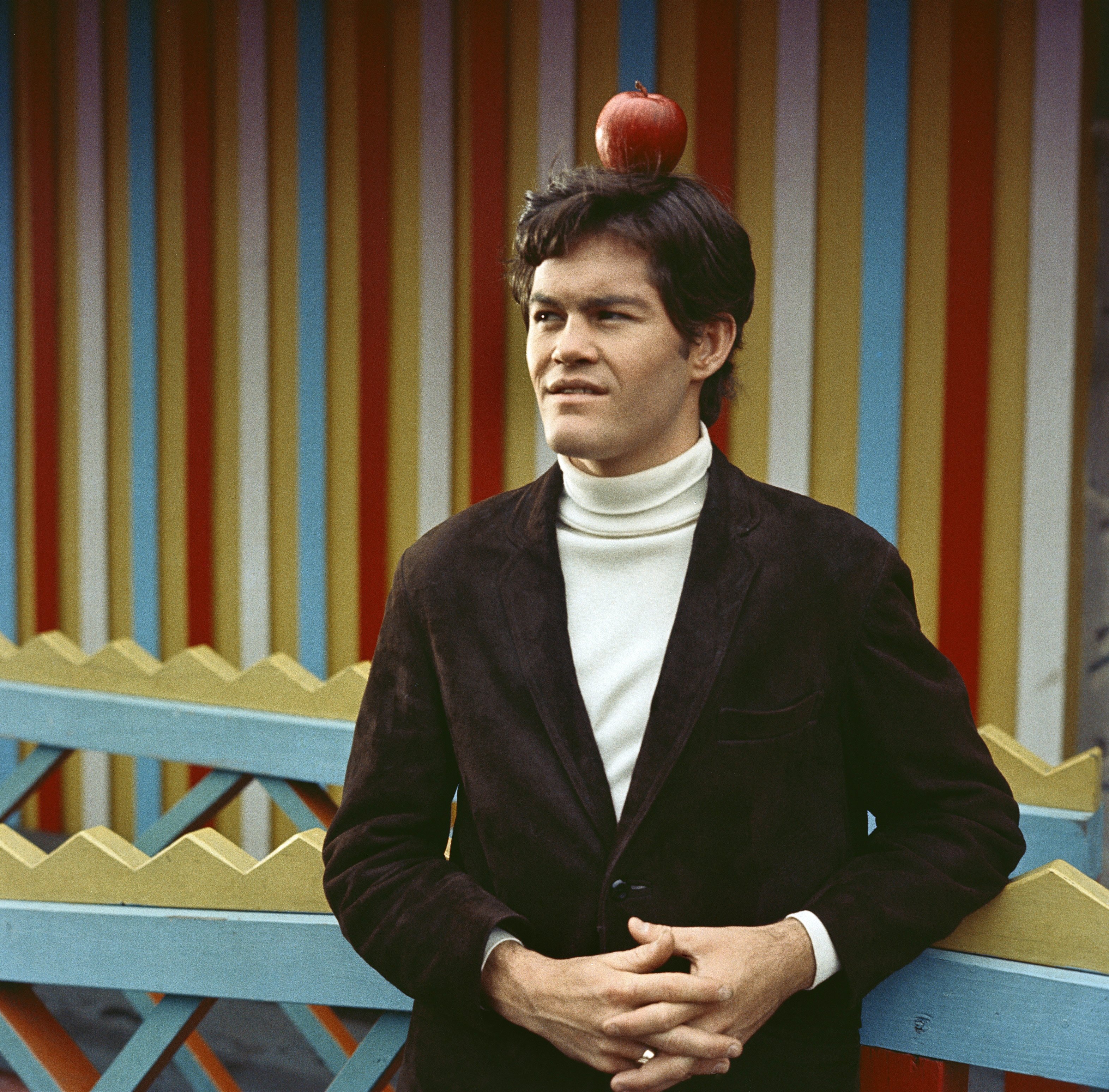 The Monkees' Micky Dolenz with an apple on his head