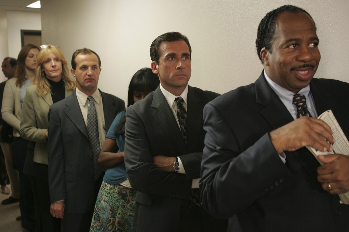 Michael Scott and Stanley Hudson wait in line for pretzels on Pretzel Day in "Initiation" (The Office Season 3, Episode 5). 