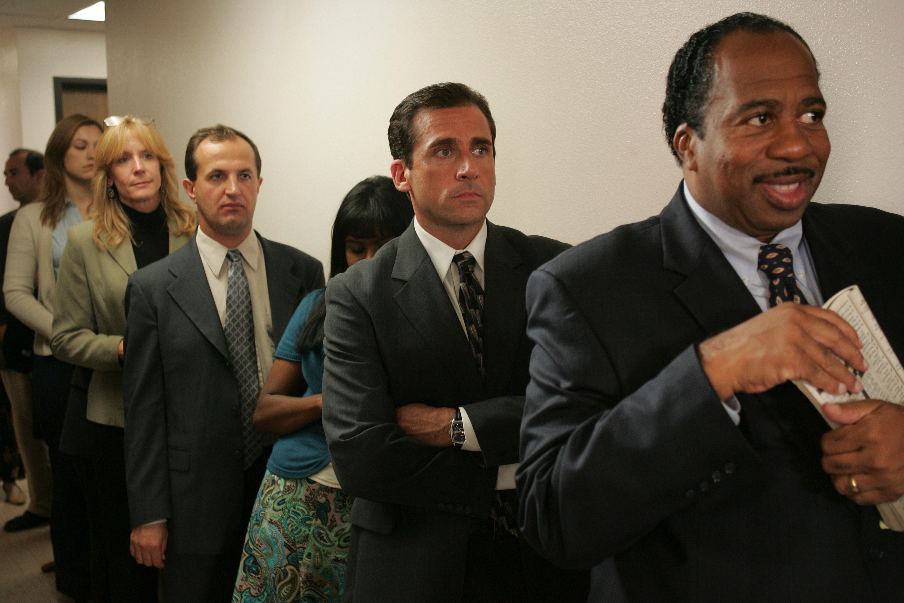 Michael Scott and Stanley Hudson wait in line for pretzels on Pretzel Day in "Initiation" (The Office Season 3, Episode 5). 