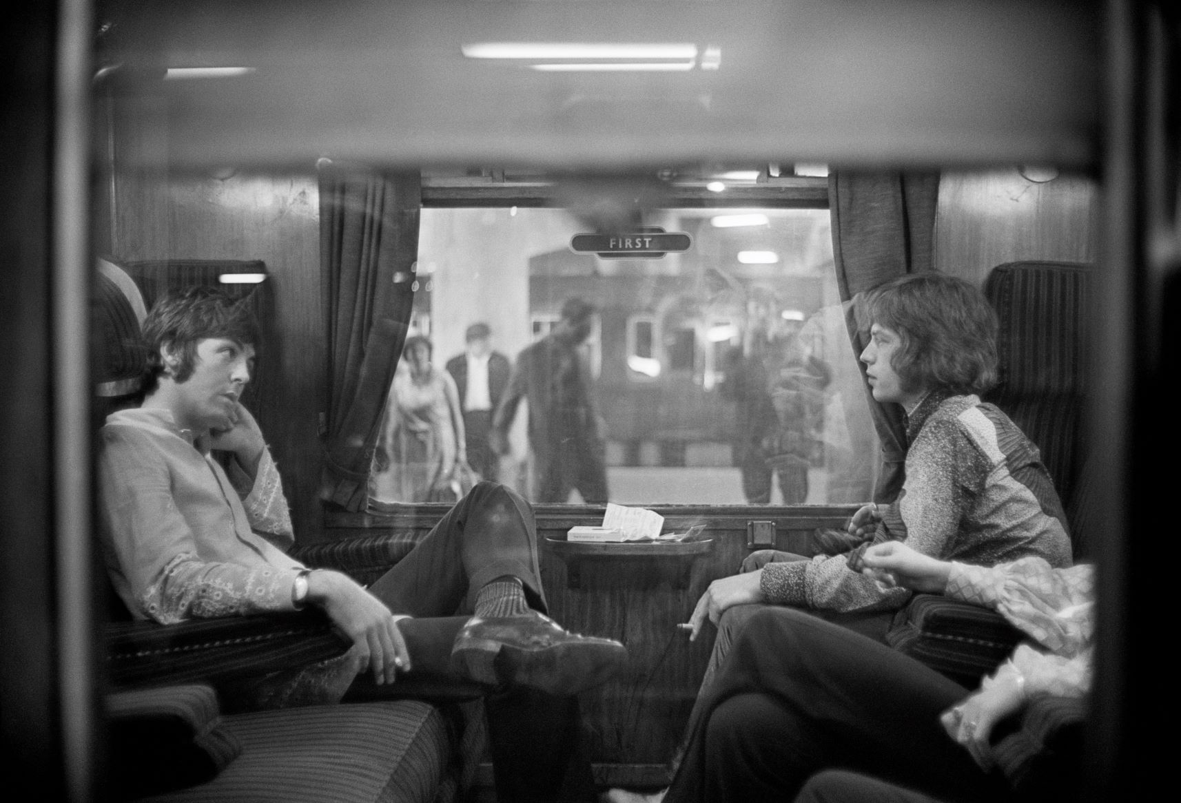 The Beatles’ Paul McCartney and The Rolling Stones’ Mick Jagger on a train