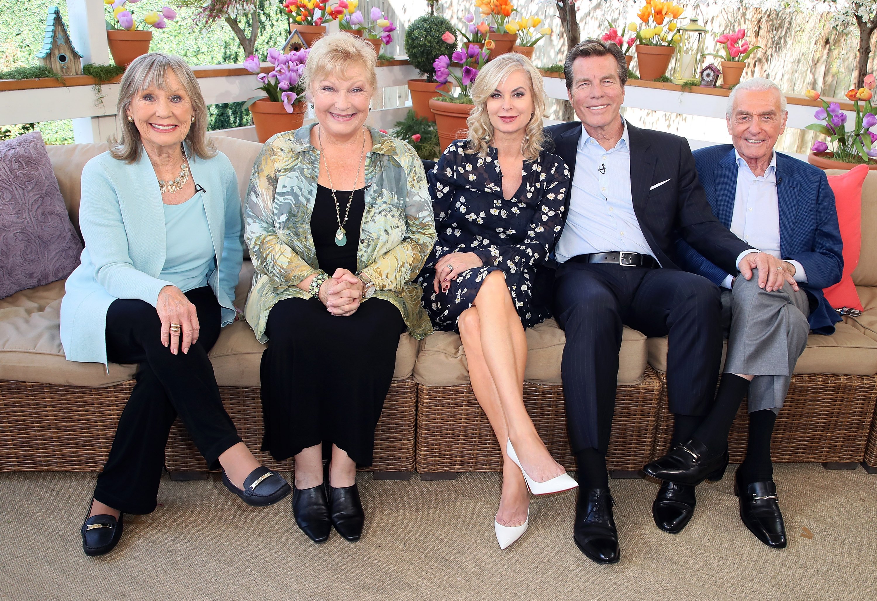 'The Young and the Restless' actors Marla Adams, Beth Maitland, Eileen Davidson, Peter Bergman, and Jerry Douglas sitting on an outdoor lounge area.