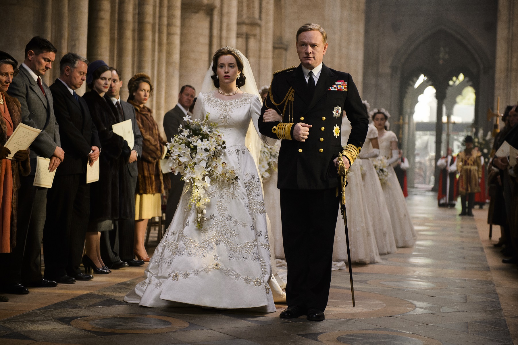 Queen Elizabeth II is walked down the aisle at her wedding in season 1 of 'The Crown'