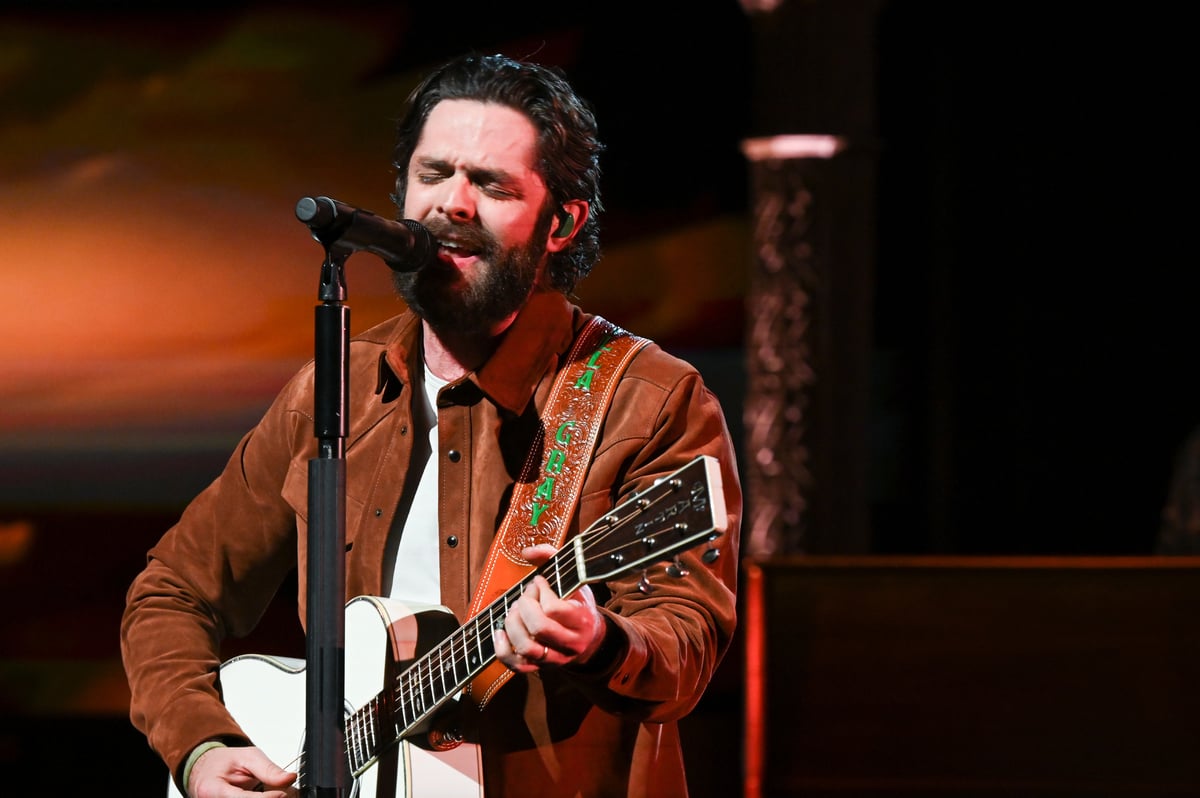 Wearing a brown shirt Thomas Rhett performs on stage at The Late Show with Stephen Colbert in New York, NY.