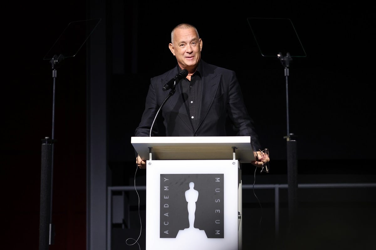 Tom Hanks smiling while speaking on stage.