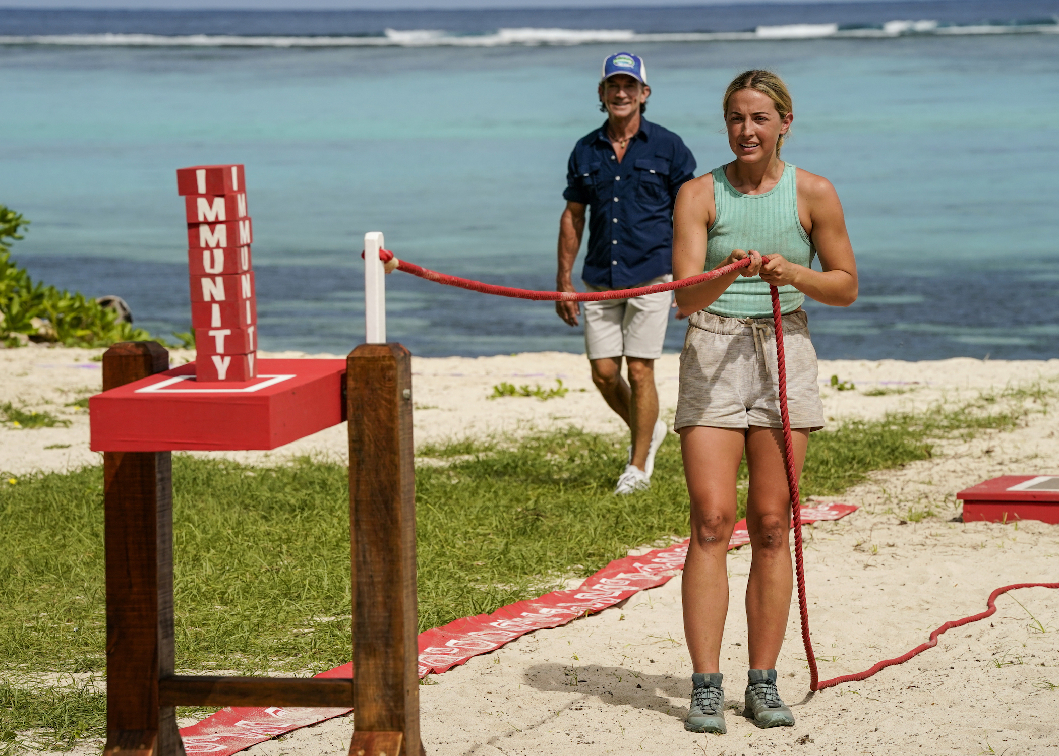 Tori holding a rope competing in an elimination with Jeff Probst behind her in 'Survivor' Season 42 Episode 6/7