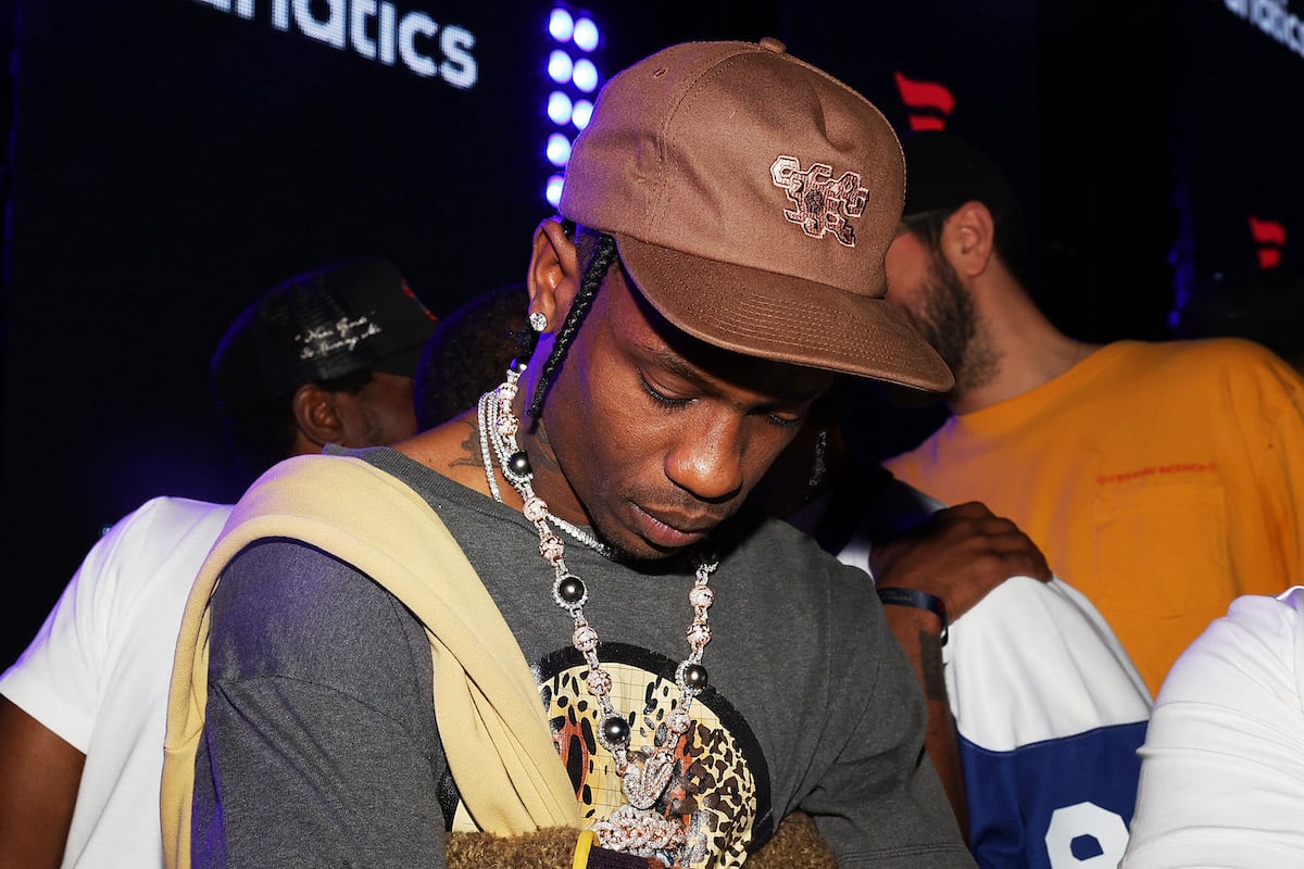 Travis Scott attends the Fanatics Super Bowl Party with his head down avoiding the cameras