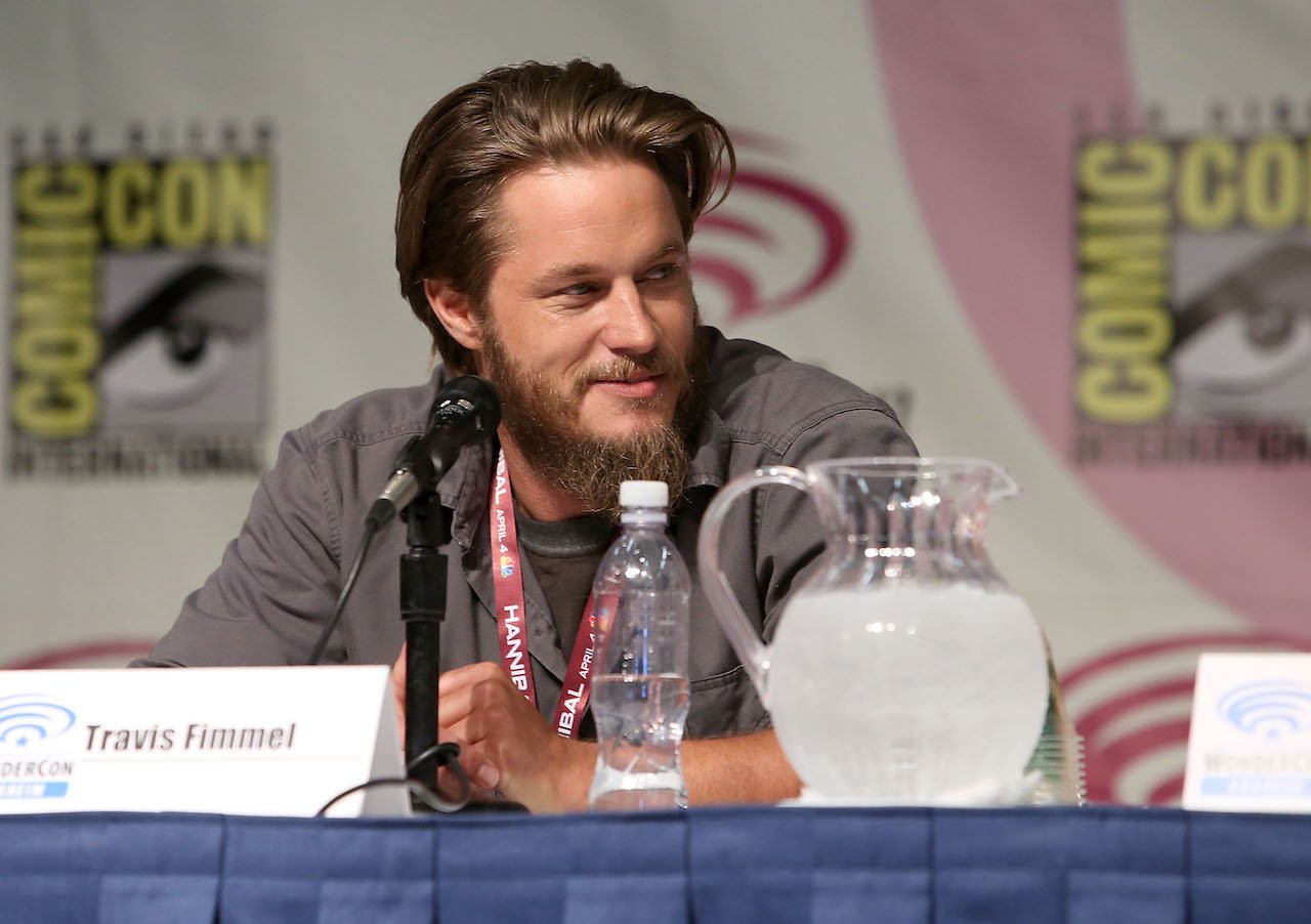 Travis Fimmel seated in front of a microphone at Comic Con in 2013