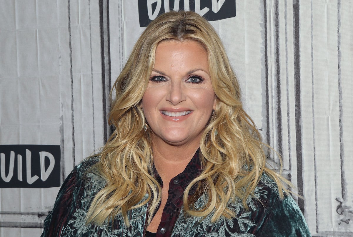 Trisha Yearwood, the creator of Slimmed Down Carrot Cake as seen on 'Trisha's Southern Kitchen,' smiles wearing a blue shirt