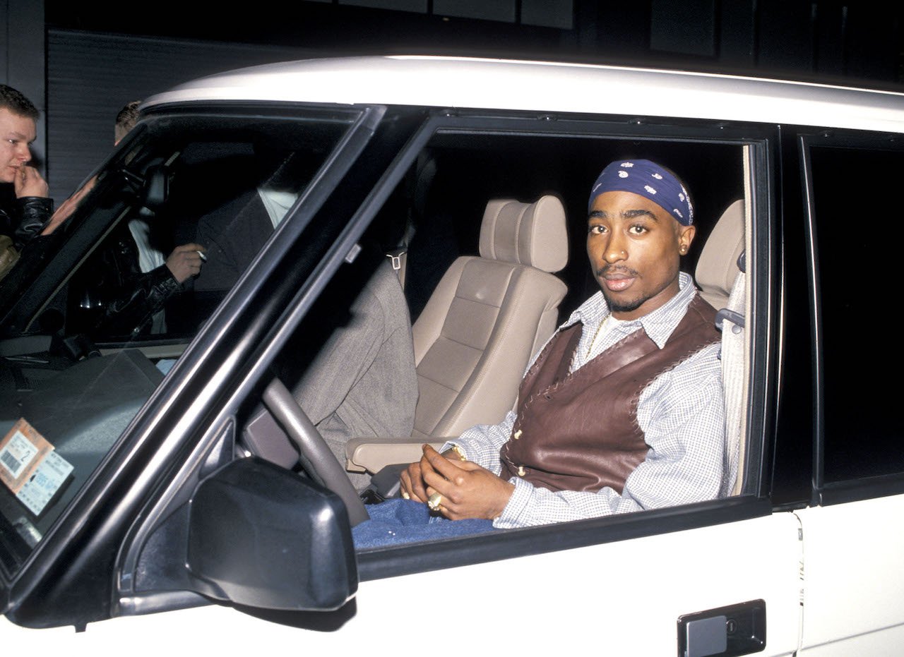 Tupac Shakur rides in car