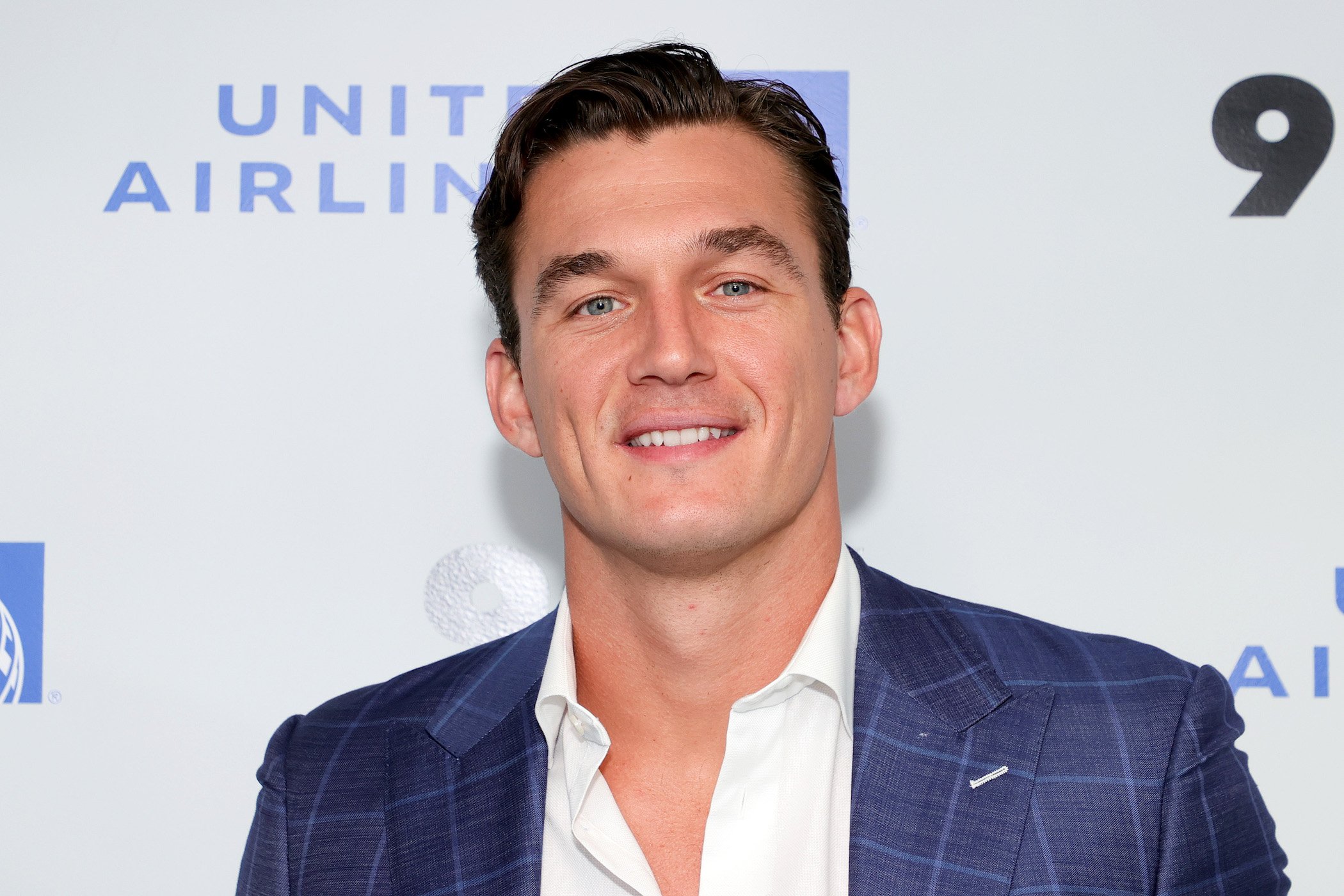 Tyler Cameron from 'The Bachelorette' smiling at an event