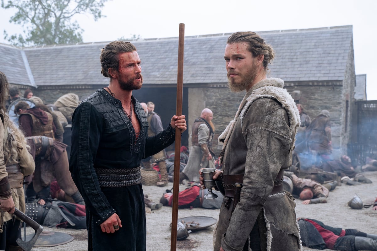 Leo Suter (Harald) and Sam Corlett (Leif) speak after a battle scene in Vikings: Valhalla Season 1. 