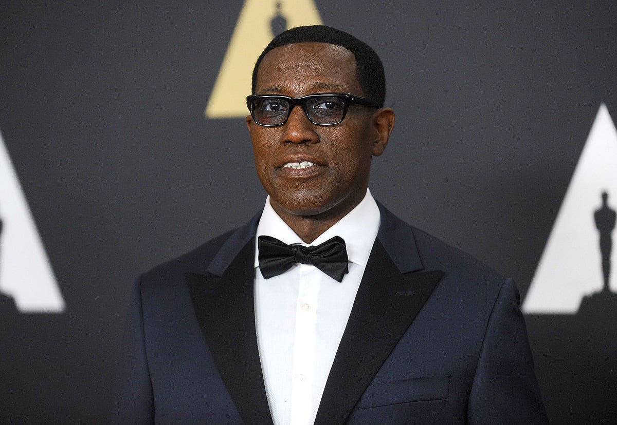 Wesley Snipes posing while wearing a blue suit.