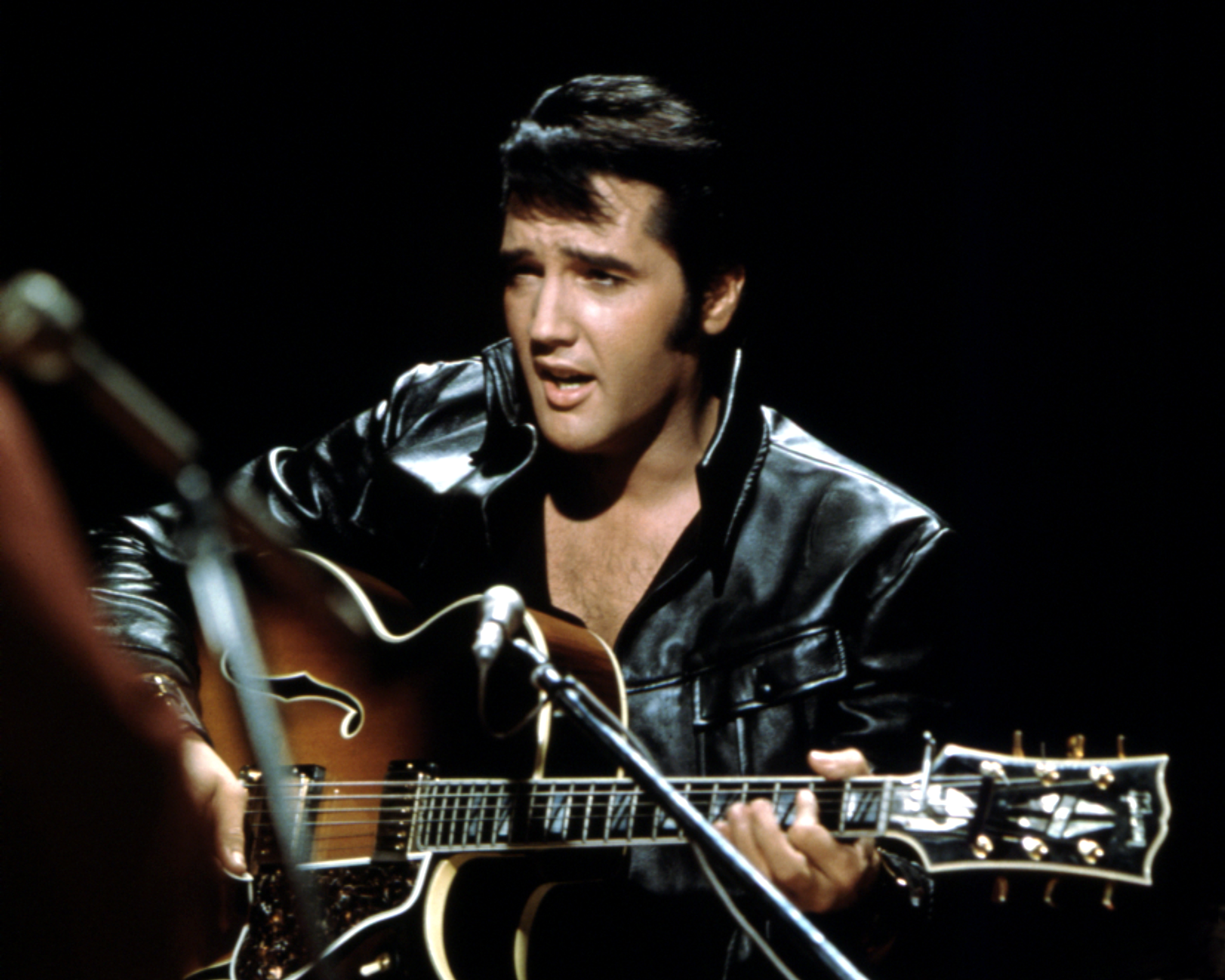 Elvis Presley wearing a black jacket