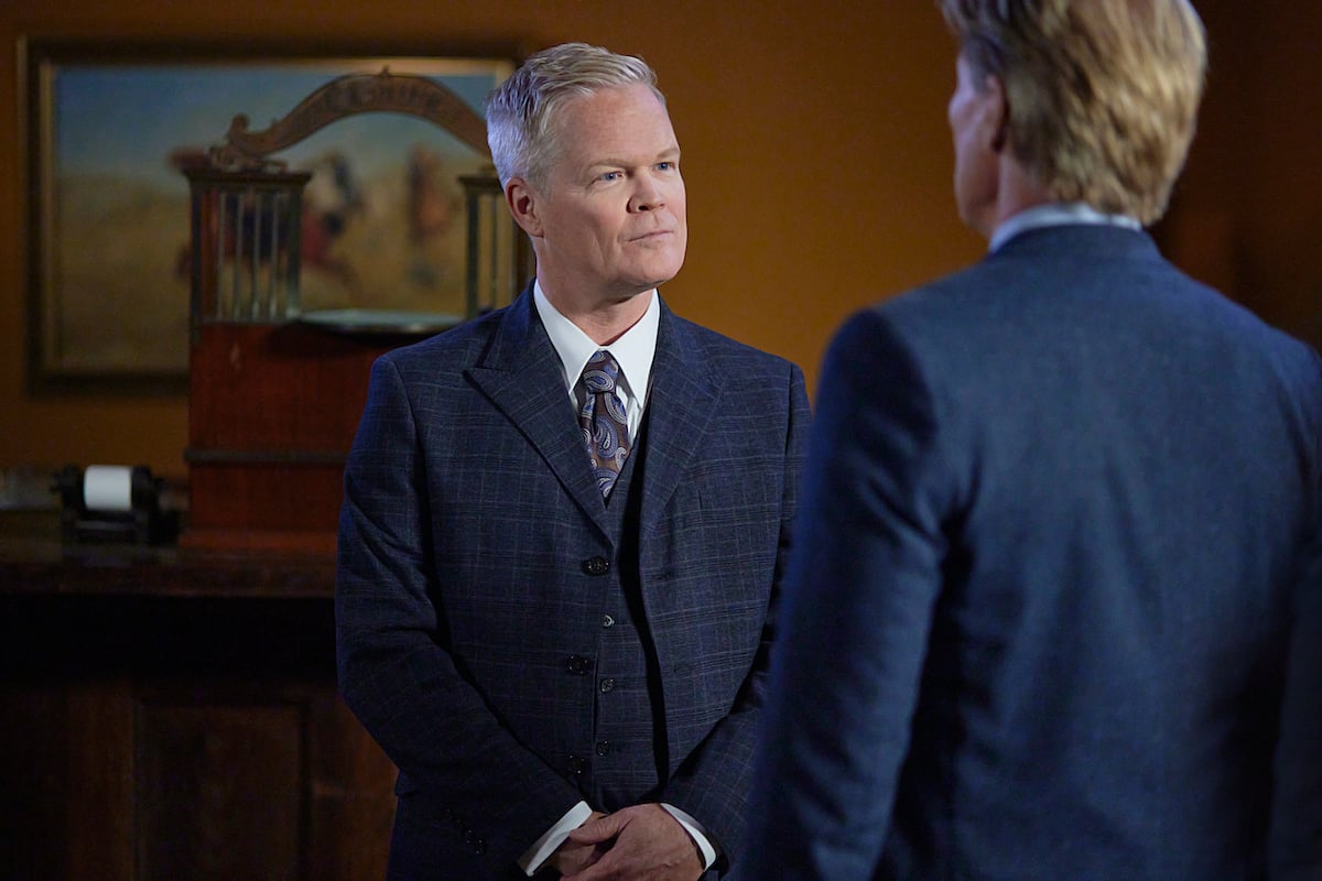 Wesley Salter as Wyman Walden, wearing a blue suit and talking to Bill, in 'When Calls the Heart' Season 9 Episode 9