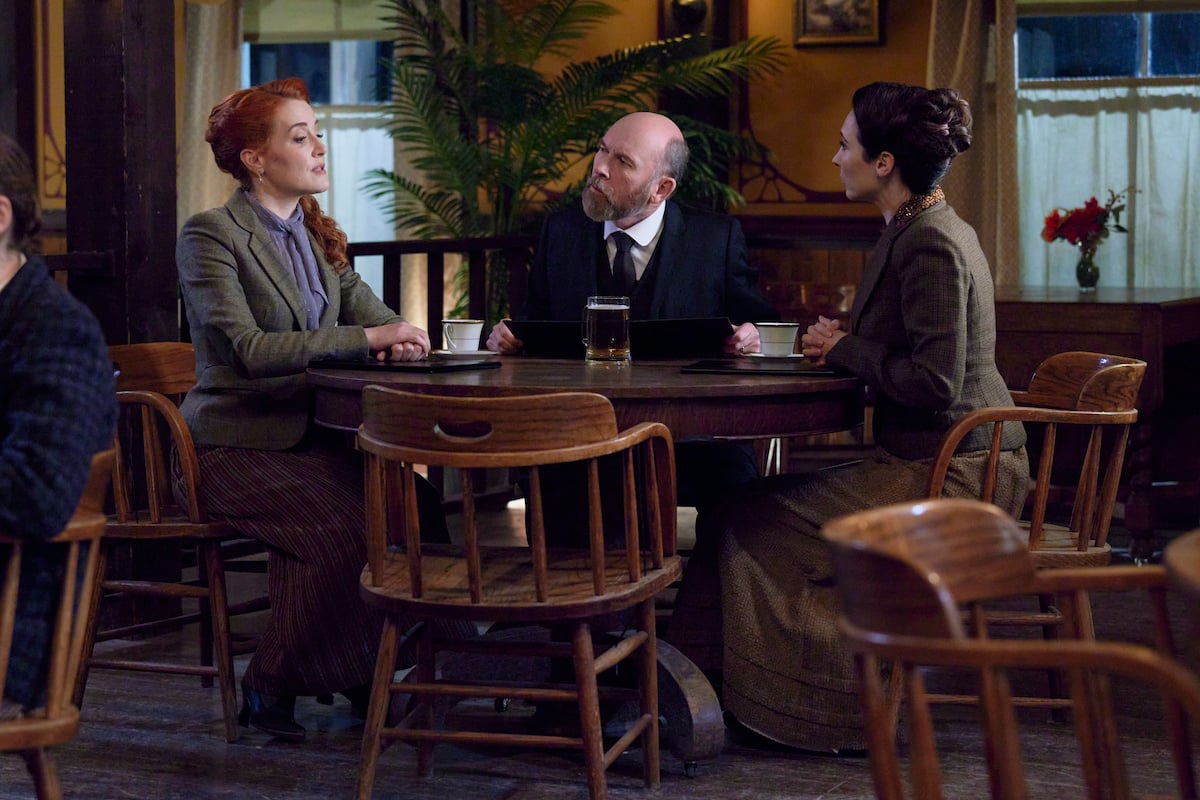 Molly, Ned, and Florence sitting around a table in 'When Calls the Heart' Season 9 Episode 9