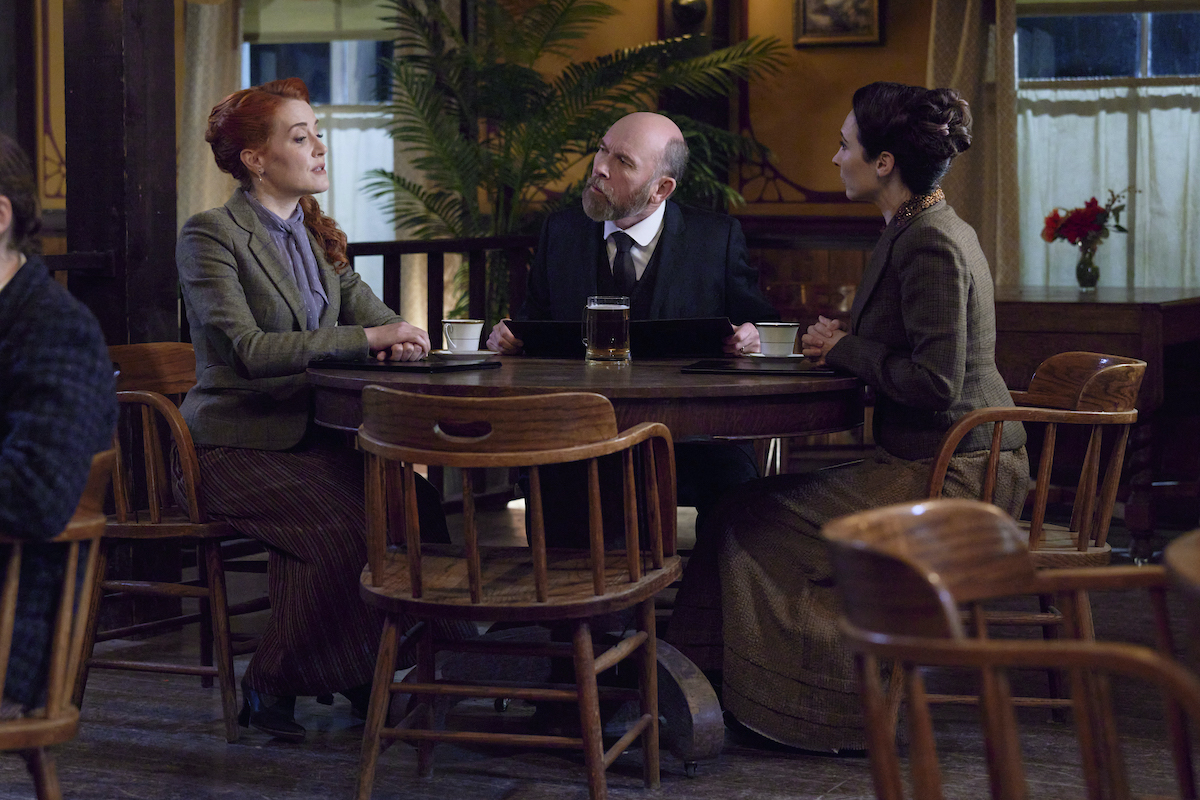 Molly, Ned, and Florence sitting around a table in 'When Calls the Heart' Season 9 Episode 9