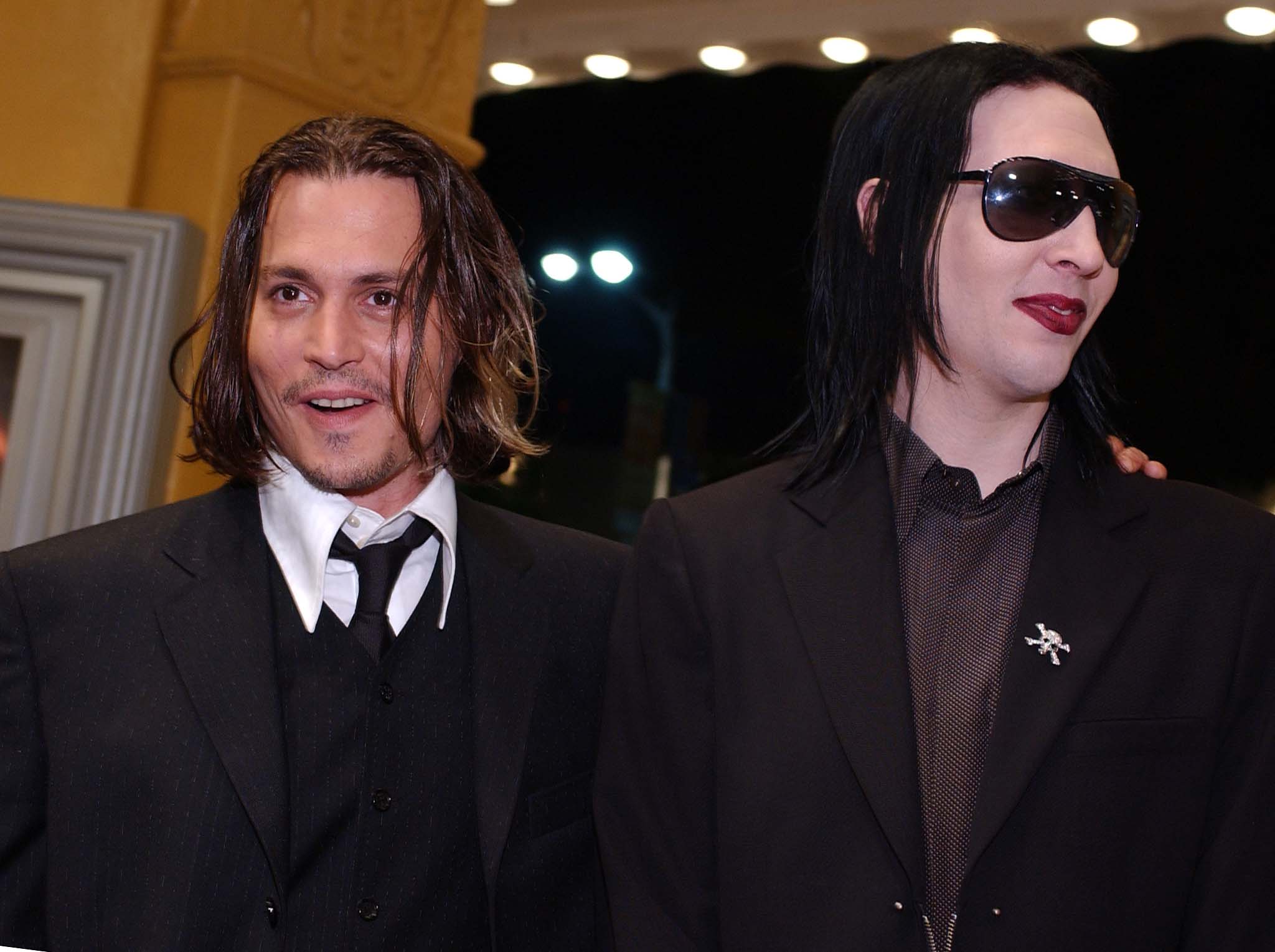 Johnny Depp and Marilyn Manson, who covered Carly Simon's "You're So Vain" together, wearing suits