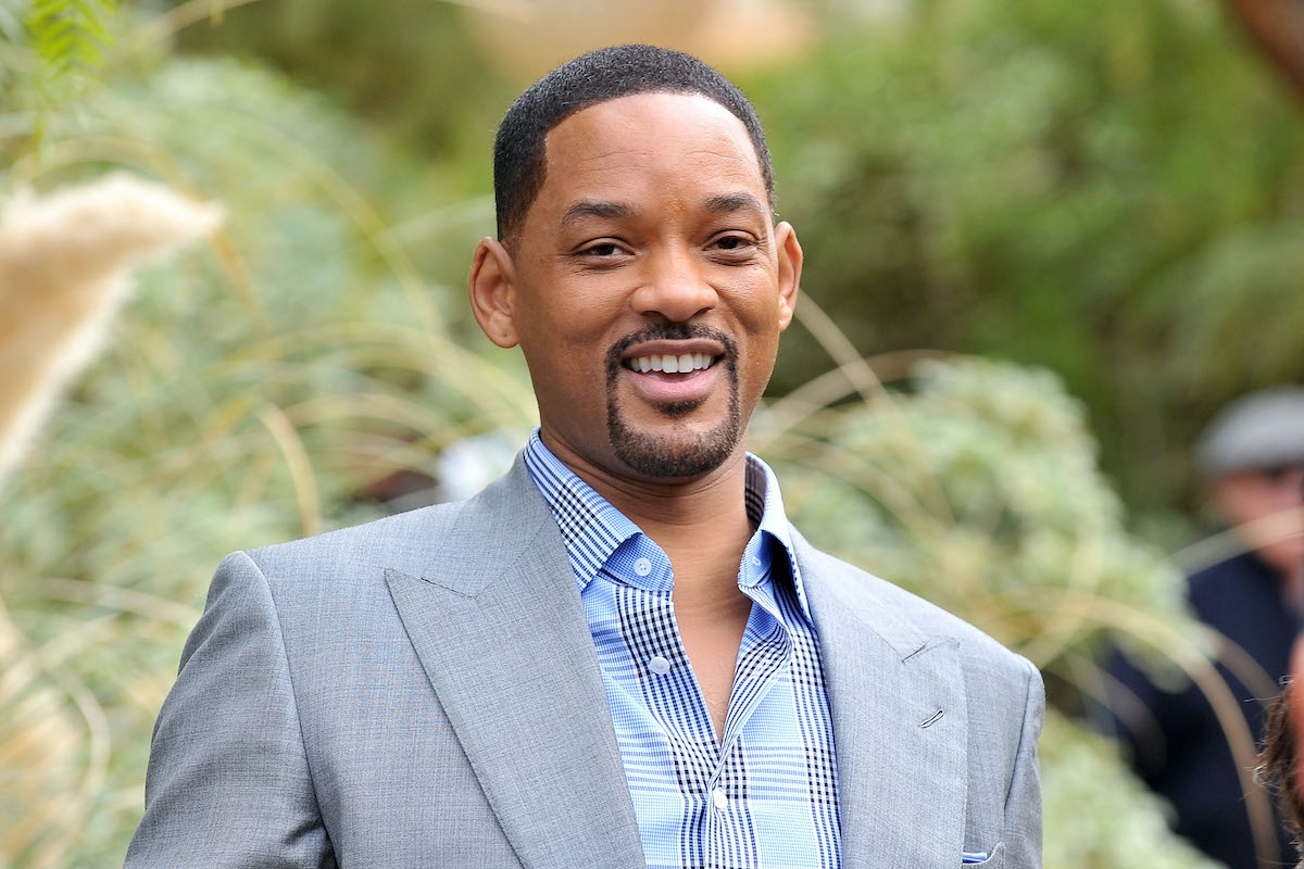 Will Smith smiles in a gray suit