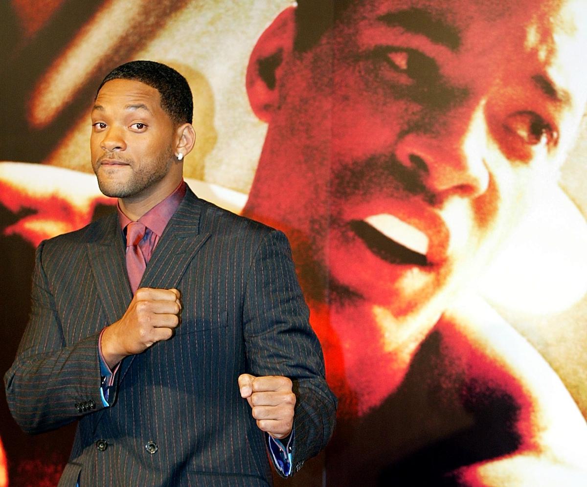 ‘Ali’ star Will Smith poses with his fists up in front of the movie’s poster