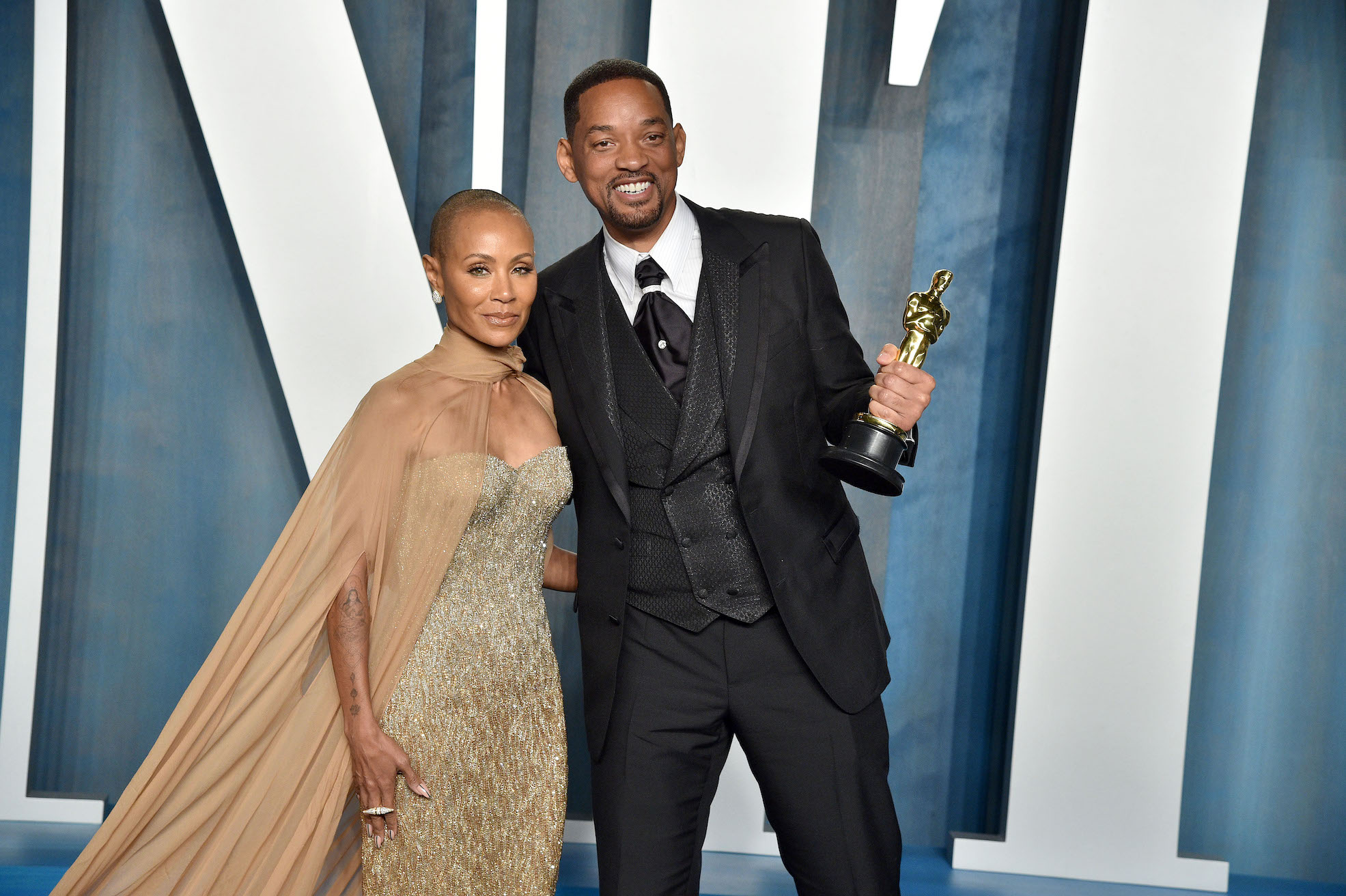 Will Smith and Jada Pinkett Smith smiling at an Oscars 2022 party