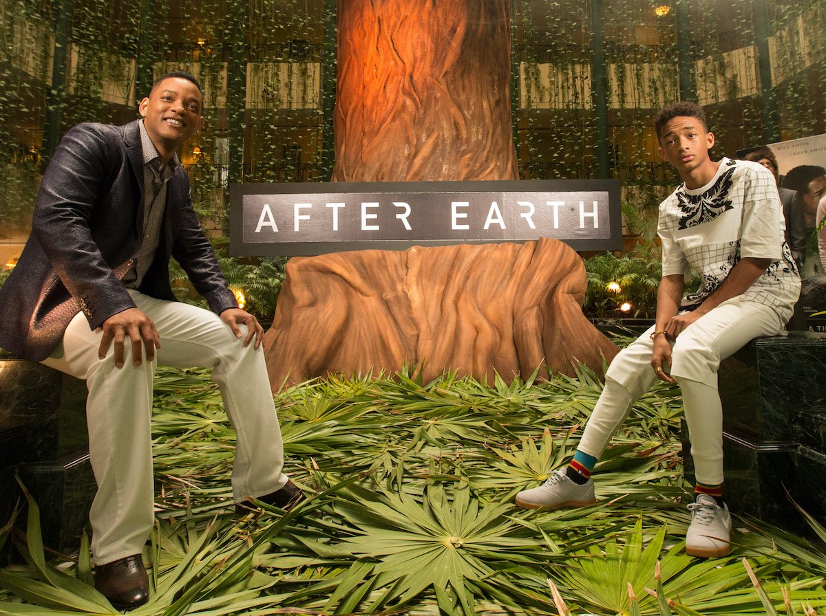 Will Smith and Jaden Smith pose in front on a background themed to their film ‘After Earth’