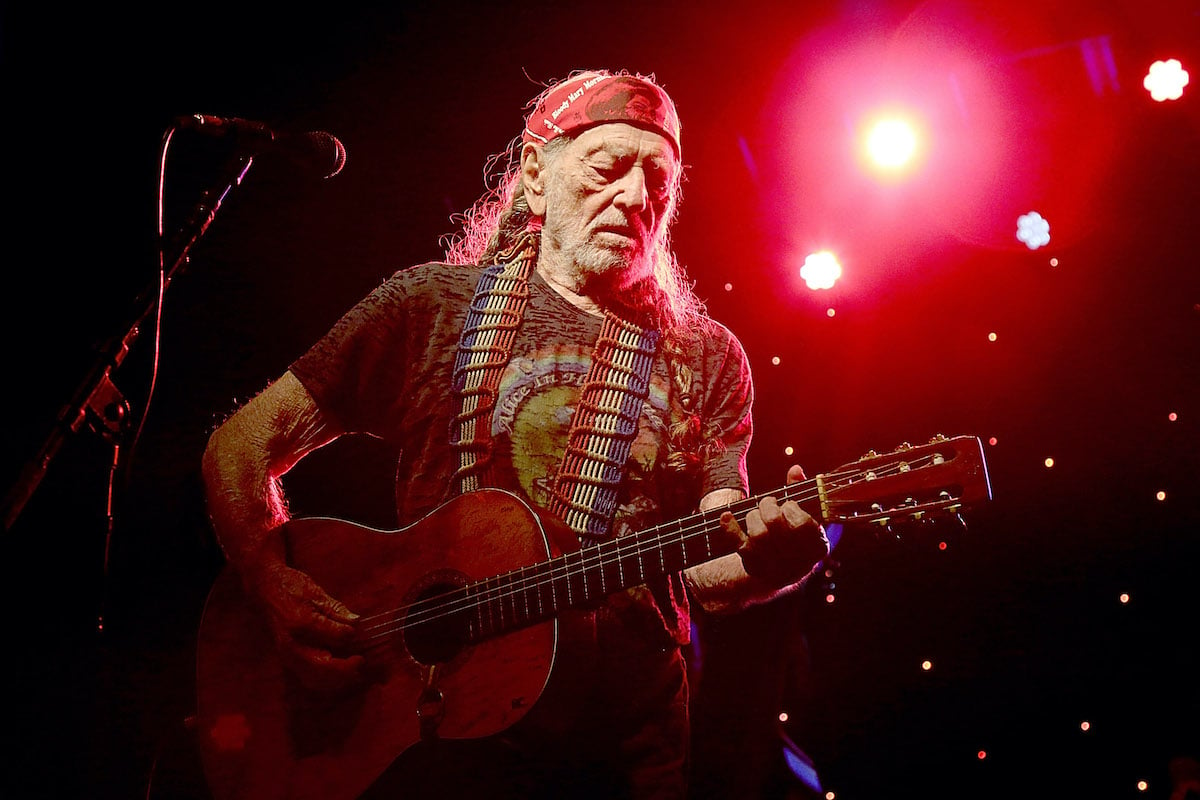 Willie Nelson performing on stage