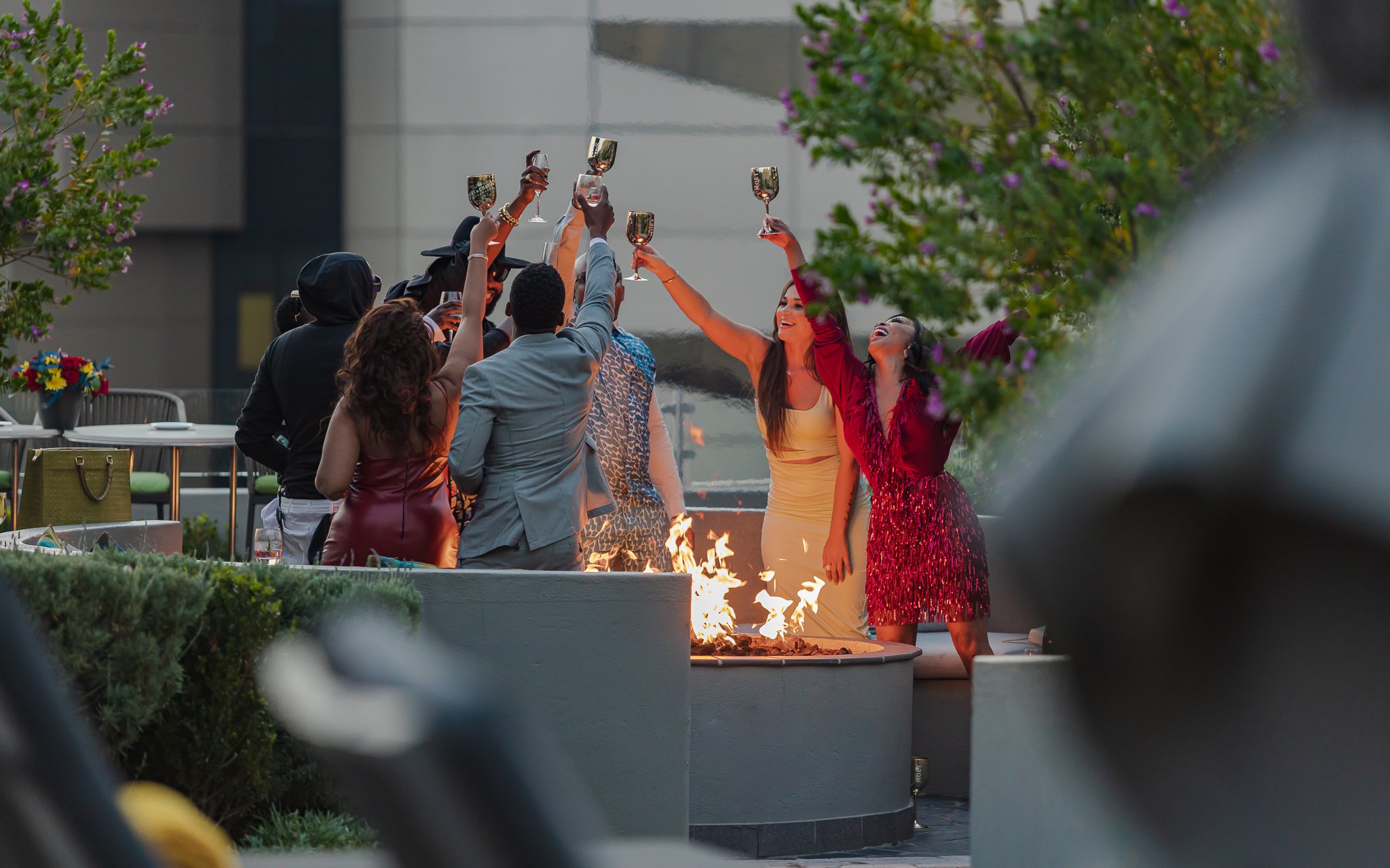 Young, Famous, and African cast toasting one another