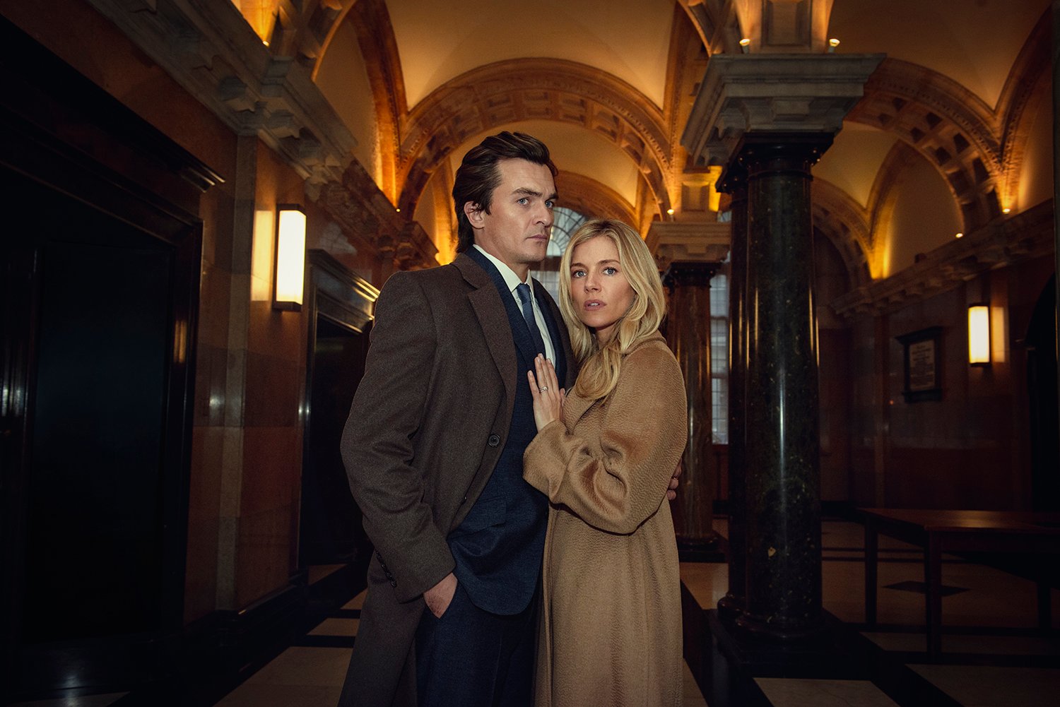 Rupert Friend as James Whitehouse and Sienna Miller as Sophie Whitehouse in Anatomy of a Scandal.