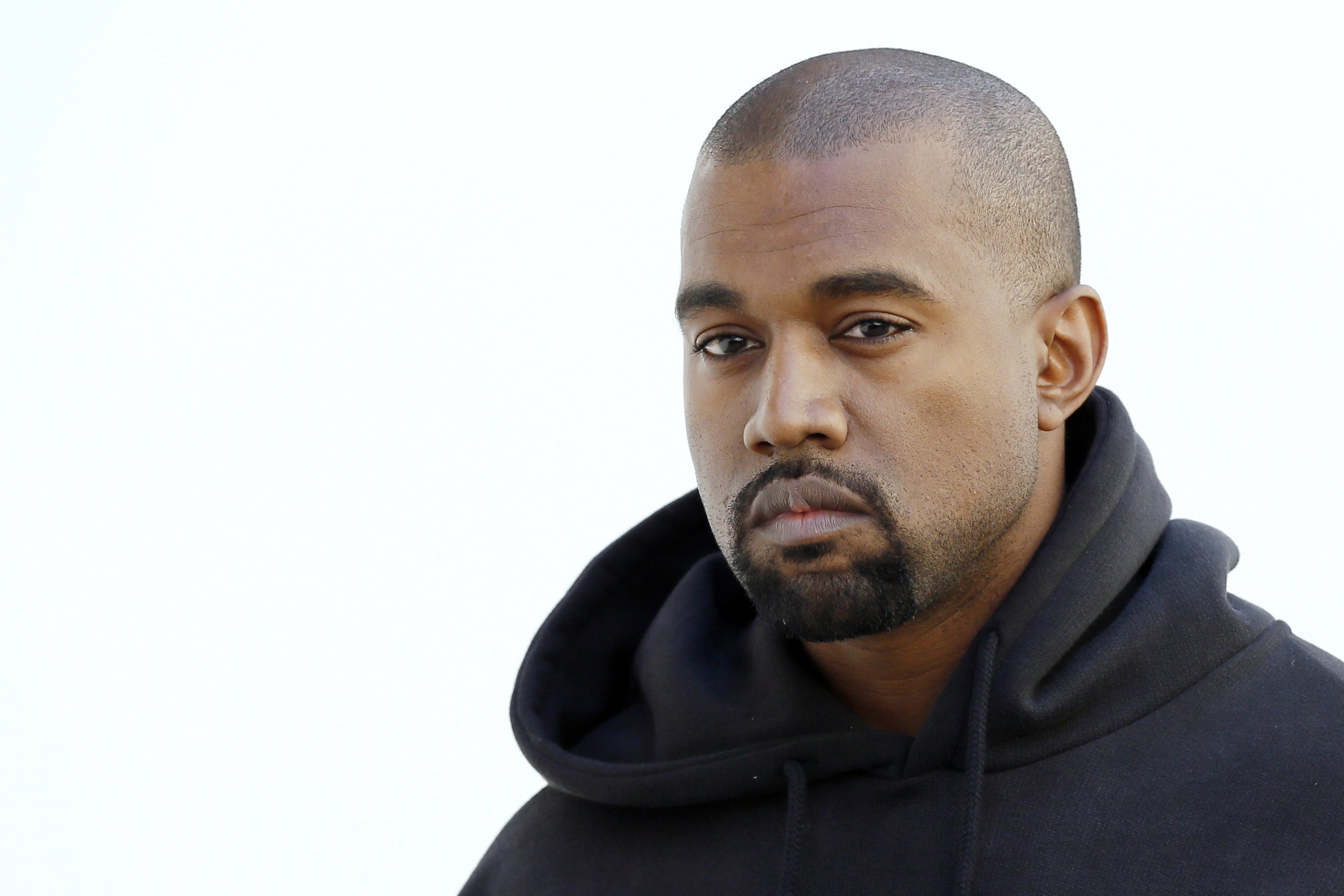 Kanye West poses at the Christian Dior fashion show in 2015