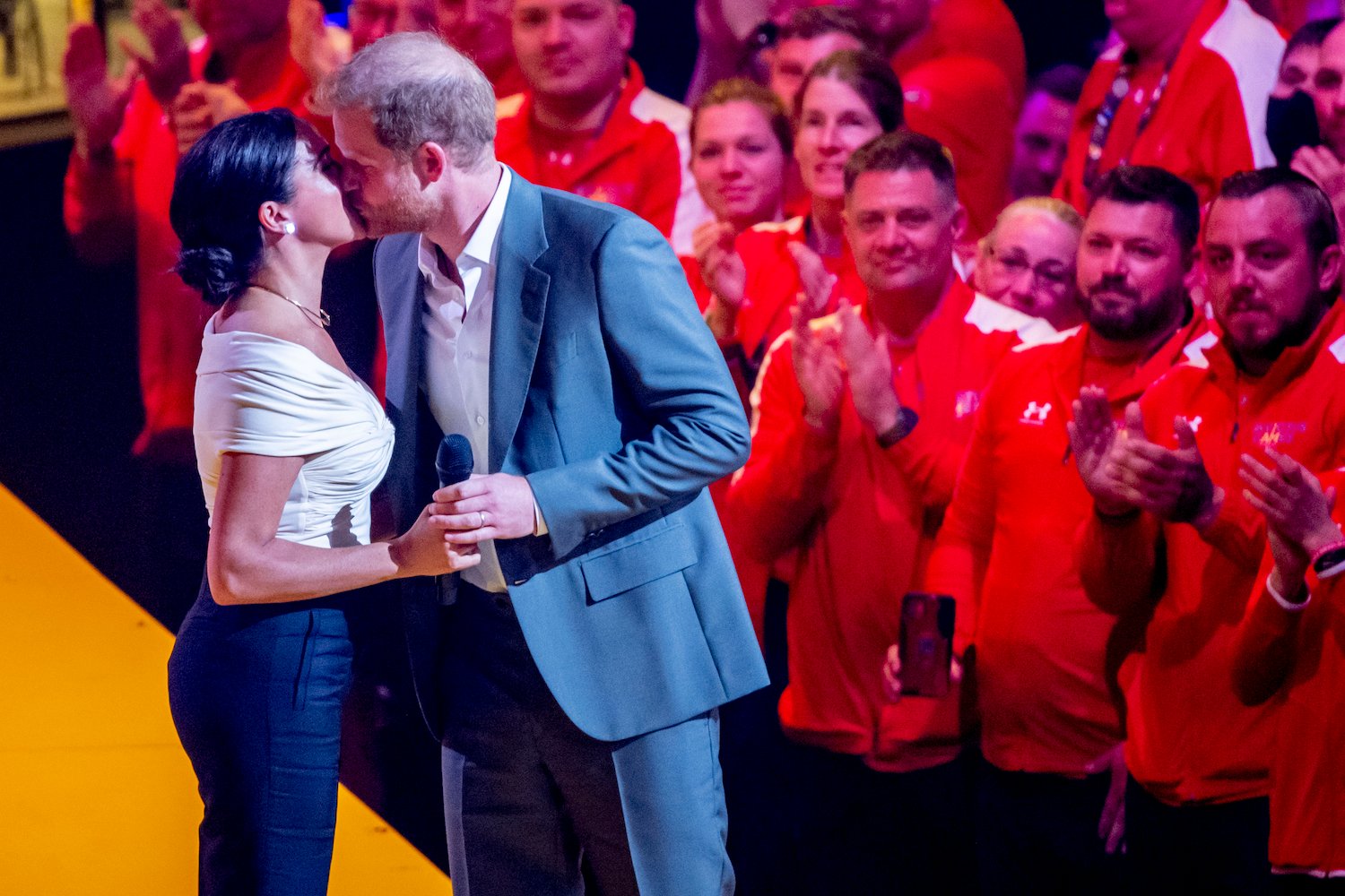 Prince Harry and Meghan Markle kiss on stage at the 2022 Invictus Games opening ceremony