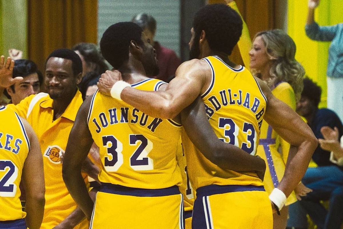 Quincy Isaiah as Magic Johnson and Solomon Hughes as Kareem Abdul-Jabbar embracing each other in their Lakers uniform in 'Winning Time'
