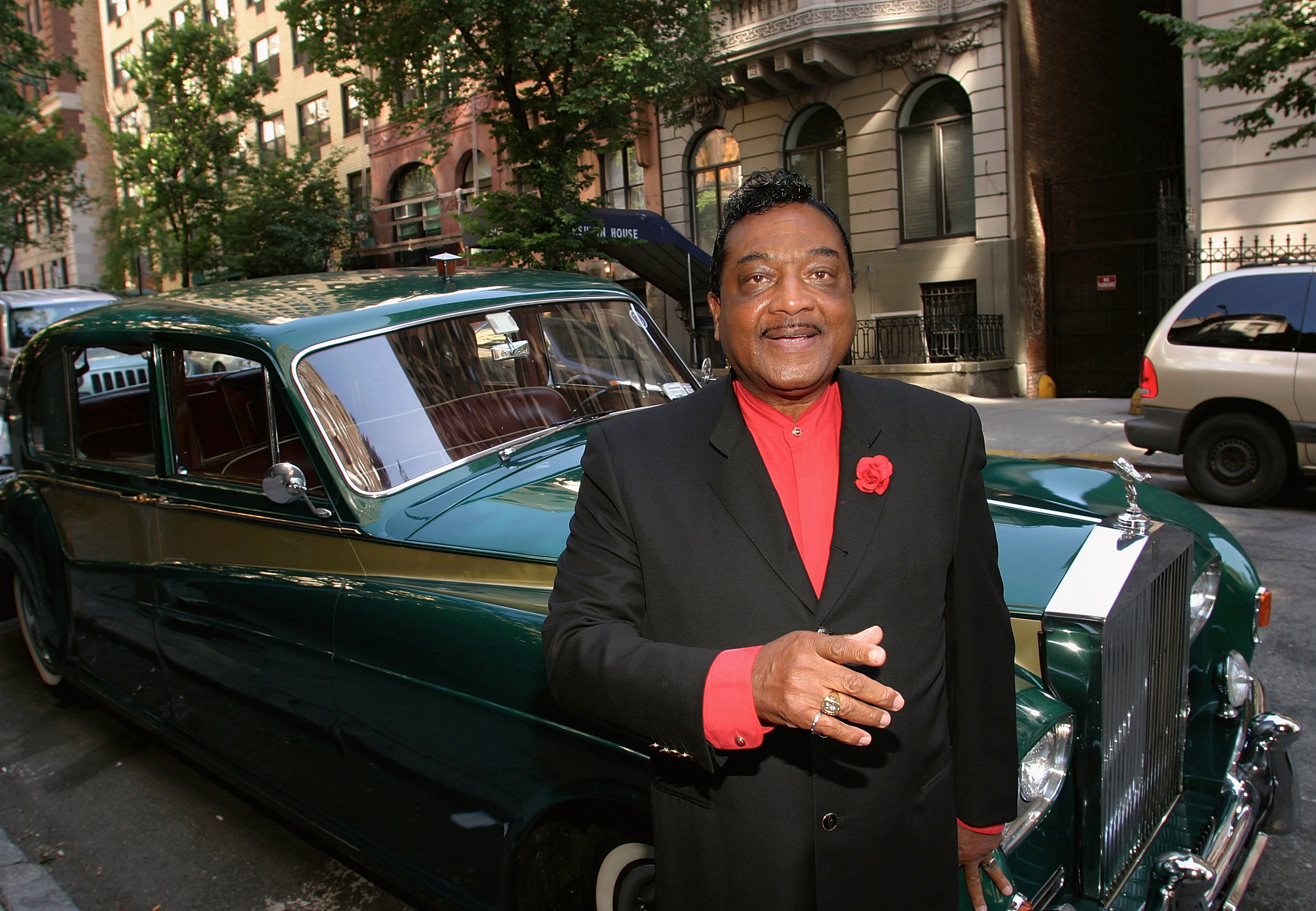 Reverend Ike in front of a car