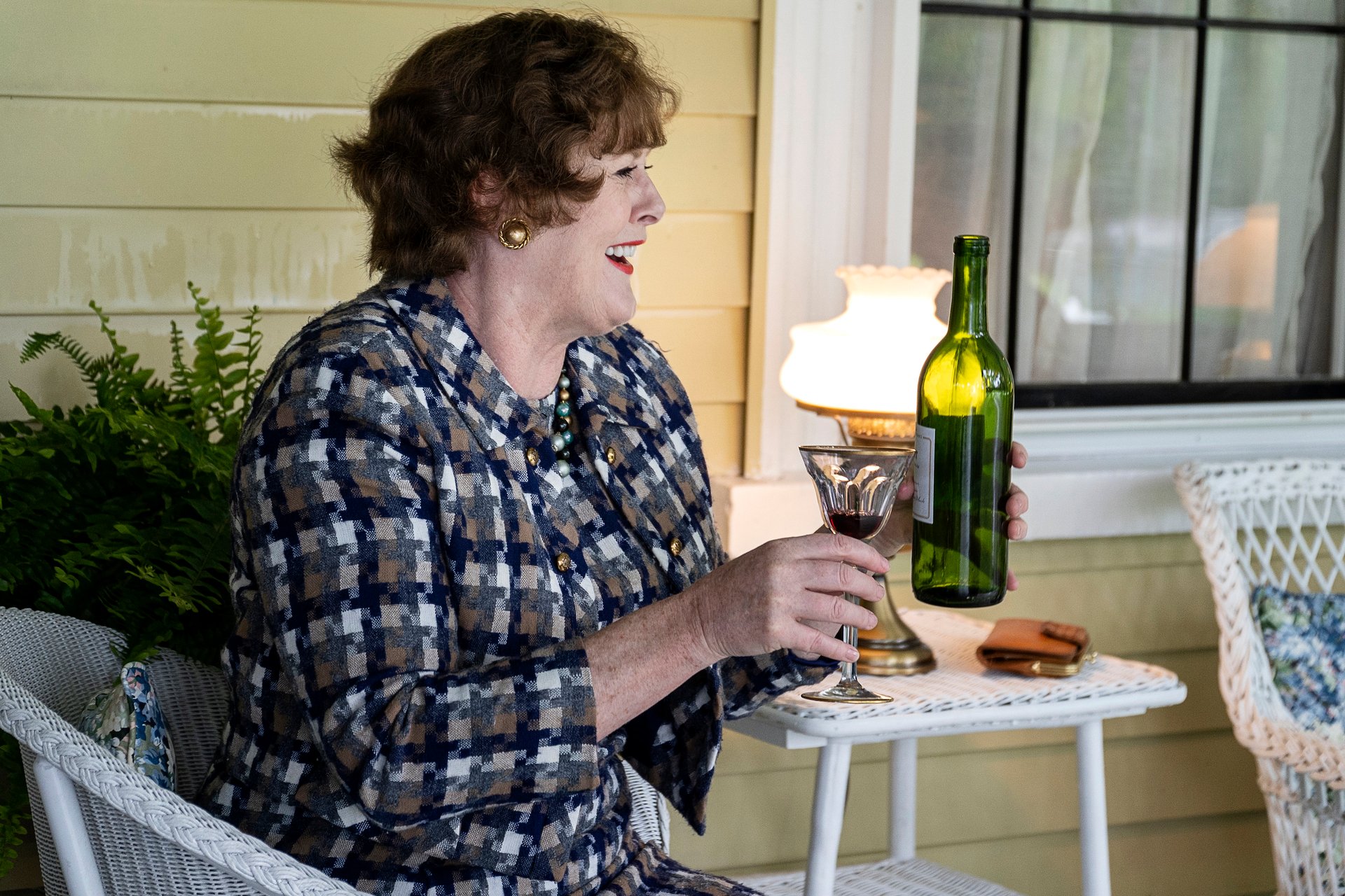 Sarah Lancashire as Julia Child sits on a patio with a drink during an episode of HBO Max's 'Julia'